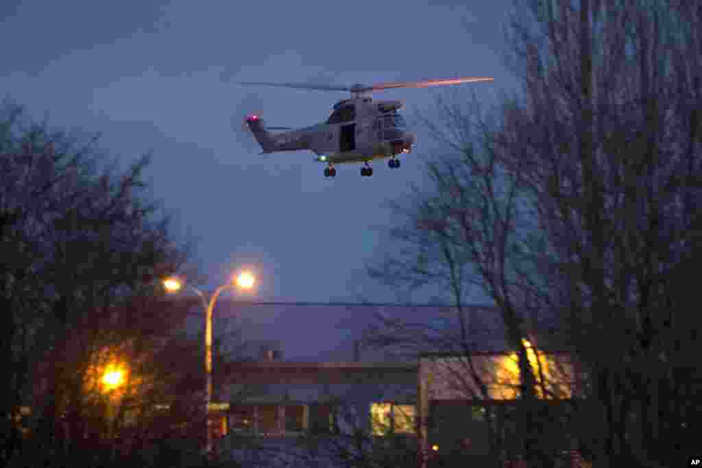 A helicopter flies over a building, where the suspects of a shooting at a Paris newspaper office were holed up, after security forces stormed it in Dammartin-en-Goele, France, Jan. 9, 2015.