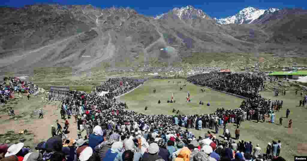 People gather to watch a polo match during the yearly Shandur Polo Festival, at Shandur Pass, at an estimated height of 3,700 meters, in Chitral, Pakistan, July 9, 2019.