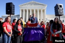 Texas Attorney General Ken Paxton speaks to a crowd of anti-abortion supporters outside the U.S. Supreme Court following arguments over a challenge to a Texas law that bans abortion after six weeks in Washington, November 1, 2021.