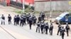 FILE - A still image taken from a video shows riot police walkin along a street in the English-speaking city of Buea, Cameroon, Oct. 1, 2017.