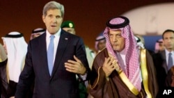 U.S. Secretary of State John Kerry, left, is escorted by Saudi Foreign Minister Prince Saud Al-Faisal bin Abdulaziz al-Saud, as Kerry arrives in Riyadh, Saudi Arabia, Nov. 3, 2013.