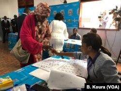 Woman voting in a polling station at the primary public school of Bastos, Yaounde 1st district.