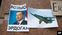 FILE - A poster showing a portrait of Turkish President Recep Tayyip Erdogan and reading "Wanted" is left after a rally protesting the downing by Ankara of a Russian jet, at the Turkish Embassy in Moscow, Nov. 25, 2015.