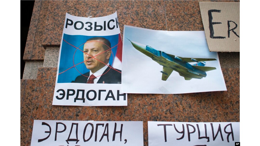 FILE - Posters showing a portrait of Turkish President Recep Tayyip Erdogan and reading "Wanted, Erdogan, Turkey," are left after a protest against Ankara's downing of a Russain warplane, at the Turkish Embassy in Moscow, Nov. 25, 2015. Bilateral relations fell to a low point following the incident but have been gradually improving.