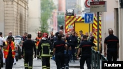Firefighters and medics are seen near the site of an explosion in central Lyon, France, May 24, 2019. 