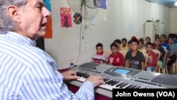 Maestro Salim Sahab with his young students at the Beyond Association center in Tripoli, Lebanon, Oct. 28, 2017.