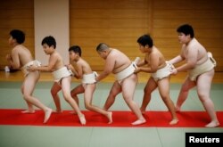 Kyuta Kumagai, 10, warms up with other boys before training, at Komatsuryu sumo club in Tokyo, Japan, August 23, 2020. "It is fun to beat people older than me," said Kyuta. (REUTERS/Kim Kyung-Hoon)