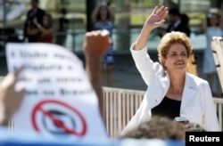 FILE - Suspended Brazilian President Dilma Rousseff waves to supporters after the Brazilian Senate voted to impeach her for breaking budget laws, at Planalto Palace in Brasilia, Brazil, May 12, 2016.