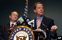 FILE - U.S. Sen. Pat Toomey, R-Pa., right, speaks during a press conference alongside U.S. Sen. Chris Coons, D-Del., in Philadelphia, March 5, 2018.