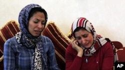 Dr. Fatima Haji, left, and Dr. Zahra al-Samak, right, react to a judge's verdict June 14, 2012, at a fellow doctor's home in Sehla, Bahrain, west of the capital Manama.