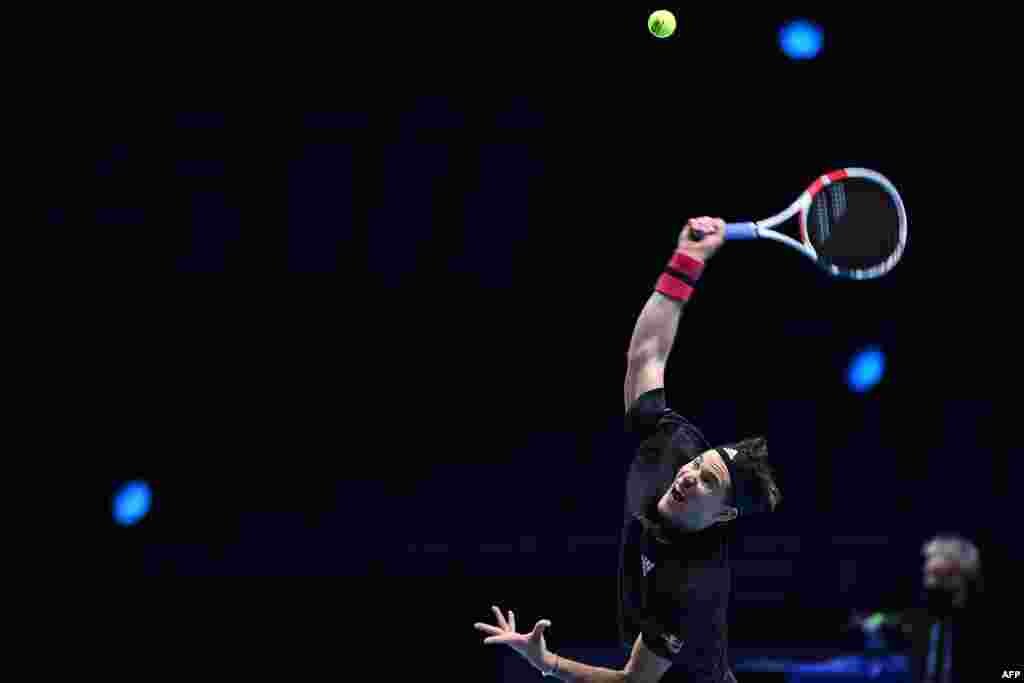 Austria's Dominic Thiem serves against Greece's Stefanos Tsitsipas in their men's singles round-robin match on day one of the ATP World Tour Finals tennis tournament at the O2 Arena in London.