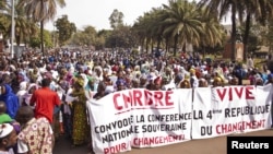 Women hold banners urging national talks to end the political paralysis in the south of Mali, in the capital Bamako, January 10, 2013.