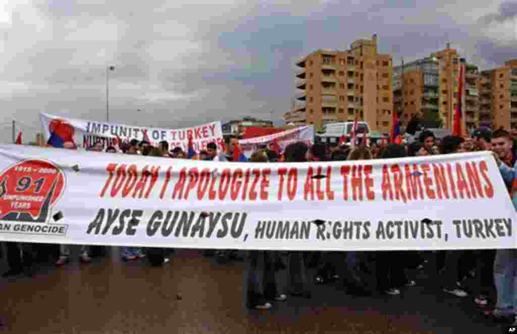 Lebanese Armenians hold a banner as they march on the main coastal highway of Antelias, on the northern entrance to Beirut, Lebanon, Monday, April 24, 2006, to mark the 91th anniversary of massacres in Turkey that began in April 1915 and in which hundreds