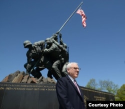David Rubenstein, at the U.S. Marine Corps War Memorial, known popularly as the Iwo Jima Memorial, is helping to fund the restoration of the iconic statue in Virginia. April 2015. (Credit: National Park Service)