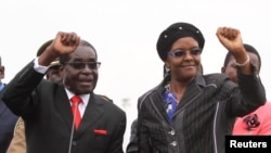 FILE - Zimbabwean President Robert Mugabe and his wife Grace wave to supporters and guests during celebrations to mark his 90th birthday in Marondera about 80km (50 miles) east of the capital Harare, Feb. 23, 2014. Mugabe turned 90 on February 21. (Reuters)