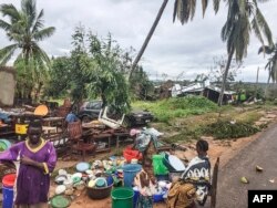 Assane Maulana rescues his belongings with his family in front of his home and shop in Macomia, following Cyclone Kenneth, April 28, 2019. Thousands of people in remote areas of storm-lashed Mozambique were homeless and bracing for imminent flooding.
