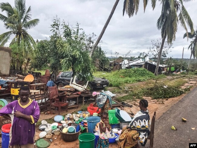 Assane Maulana rescues his belongings with his family in front of his home and shop in Macomia, following Cyclone Kenneth, April 28, 2019. Thousands of people in remote areas of storm-lashed Mozambique were homeless and bracing for imminent flooding.