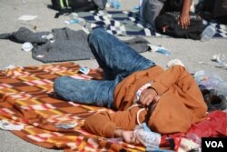 By the time they get to Croatia, many travelers are exhausted and sleep where ever they can find a place to lie down. (VOA / H. Murdock)