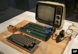 FILE - An Apple 1 computer for sale at auction is seen at the Computer History Museum in Menlo Park, California. The computer sold July 8, 2013, for $387,750 at a Christie's online-only auction.