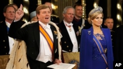Dutch King Willem-Alexander takes the oath as he wife Queen Maxima stands at his side during his inauguration inside the Nieuwe Kerk or New Church in Amsterdam, The Netherlands, Apr. 30, 2013.