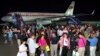 FILE - A group of tourists from Shanghai, China, arrive at an airport in Pyongyang.