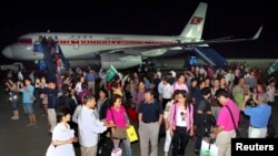 FILE - A group of tourists from Shanghai, China, arrive at an airport in Pyongyang.
