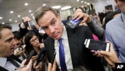 FILE - Senate Intelligence Committee Vice Chairman Mark Warner, D-Virginia, whose panel is investigating Russian interference in the 2016 election, speaks with reporters at the Capitol in Washington, June 22, 2017.