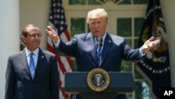 FILE - In this May 11, 2018 photo, President Donald Trump speaks during an event about prescription drug prices with Health and Human Services Secretary Alex Azar in the Rose Garden of the White House in Washington. 