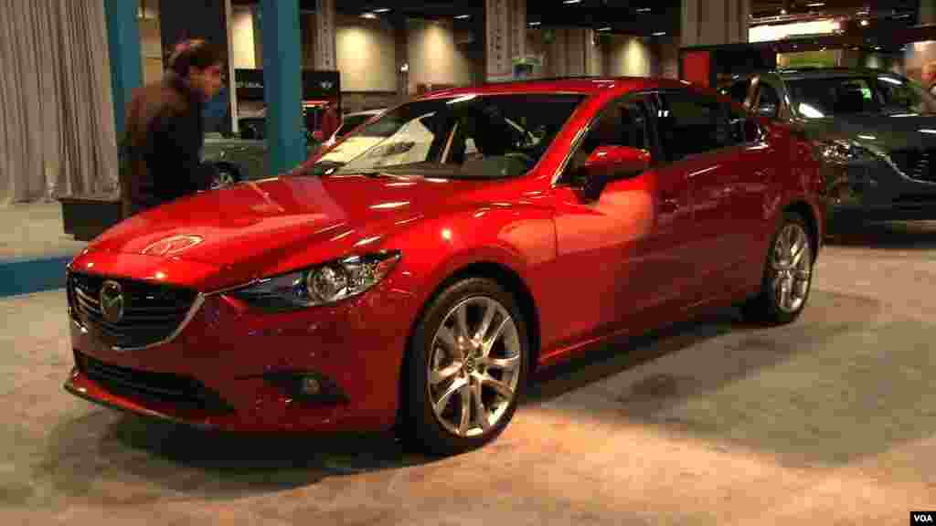 一名华盛顿车展观众检视一辆马自达（Mazda）新车。