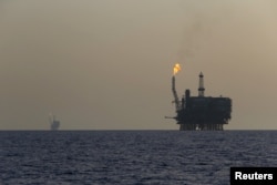 FILE - Offshore oil platforms are seen at the Bouri Oil Field off the coast of Libya, Aug. 3, 2015.