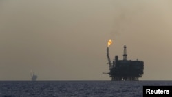 FILE - Offshore oil platforms are seen at the Bouri Oil Field off the coast of Libya, Aug. 3, 2015. 