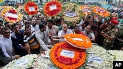 FILE - Local residents pay their respects to the victims of the attack at the Holey Artisan Bakery at a stadium in Dhaka, Bangladesh, July 4, 2016. 