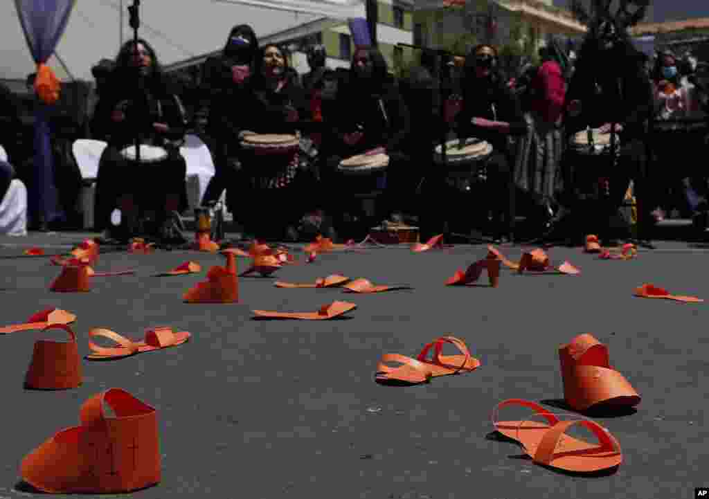 Orange colored paper shoes representing victims of violence are displayed on a road during a demonstration marking the International Day for the Elimination of Violence against Women, in La Paz, Bolivia.
