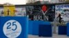 A sign, which reads "25 years Fall of the Wall 2014," is pictured in front of sections at the East Side Gallery, the largest remaining part of the former Berlin Wall in Berlin, Nov. 3, 2014. 