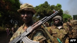 A picture taken on January 10, 2013 shows Seleka rebel coalition members take up positions in a village 12 kilometers from Damara, where troops of the regional African force FOMAC are stationed.
