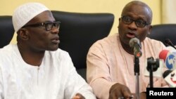 Lateef Aderemi Ibirogba, Lagos' State Commissioner for Information and Strategy (L), sits with Dr. Jide Idris, the Commissioner for Health, during a news conference on the death of an Ebola victim in Lagos, July 25, 2014.