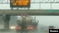 A sign warns drivers of icy conditions on Interstate 66 in Manassas, Virginia, outside of Washington December 8, 2013. 