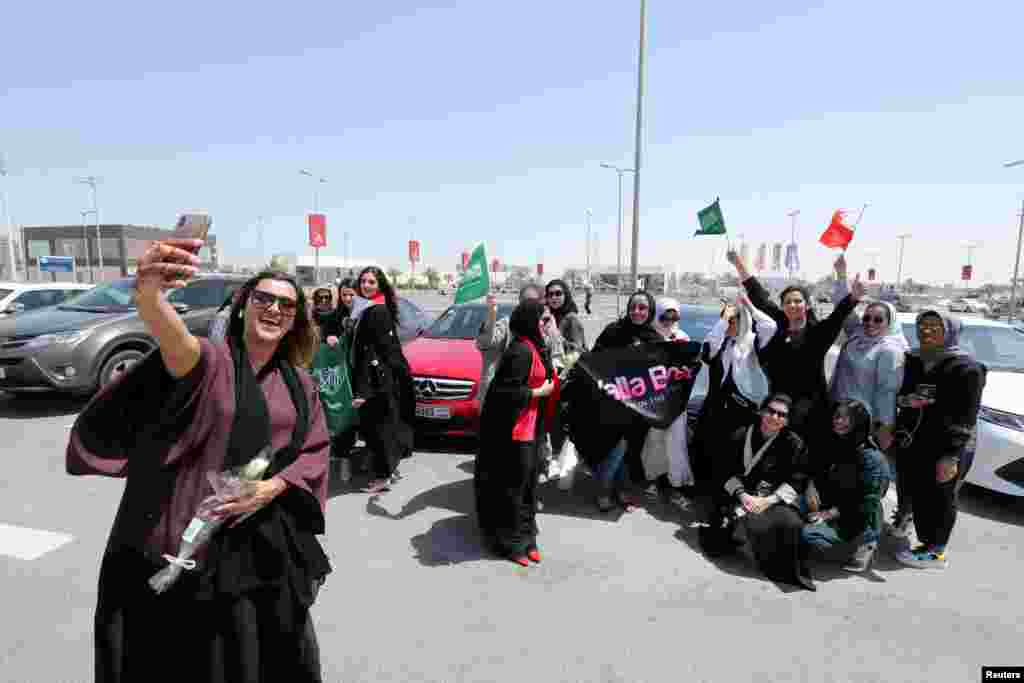 Bahraini woman Eman Mohammed takes a selfie with her phone as she celebrates with Saudi and Bahraini women the lifting ban on women drivers, in east Saudi Arabia.