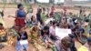 FILE - Women listen to a speaker at a protest against an ongoing conflict between government forces and armed separatists, in Bamenda, Cameroon, Sept. 7, 2018. (M.E. Kindzeka/VOA)