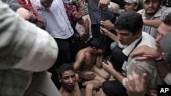 Egyptian protesters capture two of some 30 men armed with knives and sticks who attempted to storm the protesters' tent camp set up in Tahrir Square in Cairo, Egypt, July 12, 2011