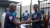 Cassius Kollie (R), 24, receives a certificate for being cured of Ebola in Paynesville, Liberia, July 20, 2015. 