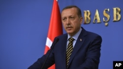 Turkey's Prime Minister Recep Tayyip Erdogan announces his new ministers in Ankara, Turkey, late Wednesday, Dec. 25, 2013. 