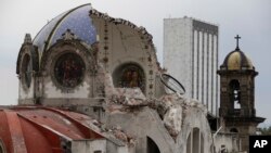 The damaged dome of Our Lady of Angels Church, which collapsed Sunday afternoon, is seen from an adjacent rooftop in the Guerrero neighborhood of Mexico City, Sept. 24, 2017. 