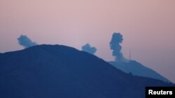 Smoke rises following airstrikes in Syria's Afrin region, as seen from near the Turkish town of Hassa, on the Turkish-Syrian border in Hatay province, Turkey, Jan. 20, 2018.