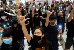 Para pemrotes anti-pemerintah berkumpul dalam sebuah demonstrasi di dalam sebuah mal di distrik Sha Tin dalam solidaritas dengan para mahasiswa pemrotes yang ditembak oleh polisi dengan amunisi langsung di Hong Kong, Cina, 2 Oktober 2019. (Foto: Reuters/Athit Perawongmetha)