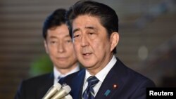 Japan's Prime Minister Shinzo Abe speaks to reporters at Abe's official residence in Tokyo, June 6, 2018, before leaving for the U.S.