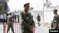 A Tunisian army officer stands guard outside the Bouchoucha military base after shooting in Tunis, Tunisia May 25, 2015. 