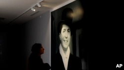 A woman looks at a picture of Carlos Gardel at his museum in Buenos Aires, Argentina, July 5, 2017. 