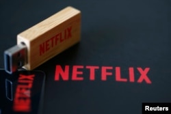 FILE - USB drive with the logo of Netflix, provider of on-demand internet streaming media, is seen in this illustration.
