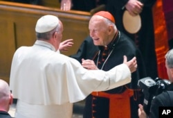 FILE - Pope Francis reaches out to hug Archbishop Emeritus Theodore McCarrick after the Midday Prayer of the Divine with more than 300 U.S. bishops at the Cathedral of St. Matthew the Apostle in Washington, Sept. 23, 2015.